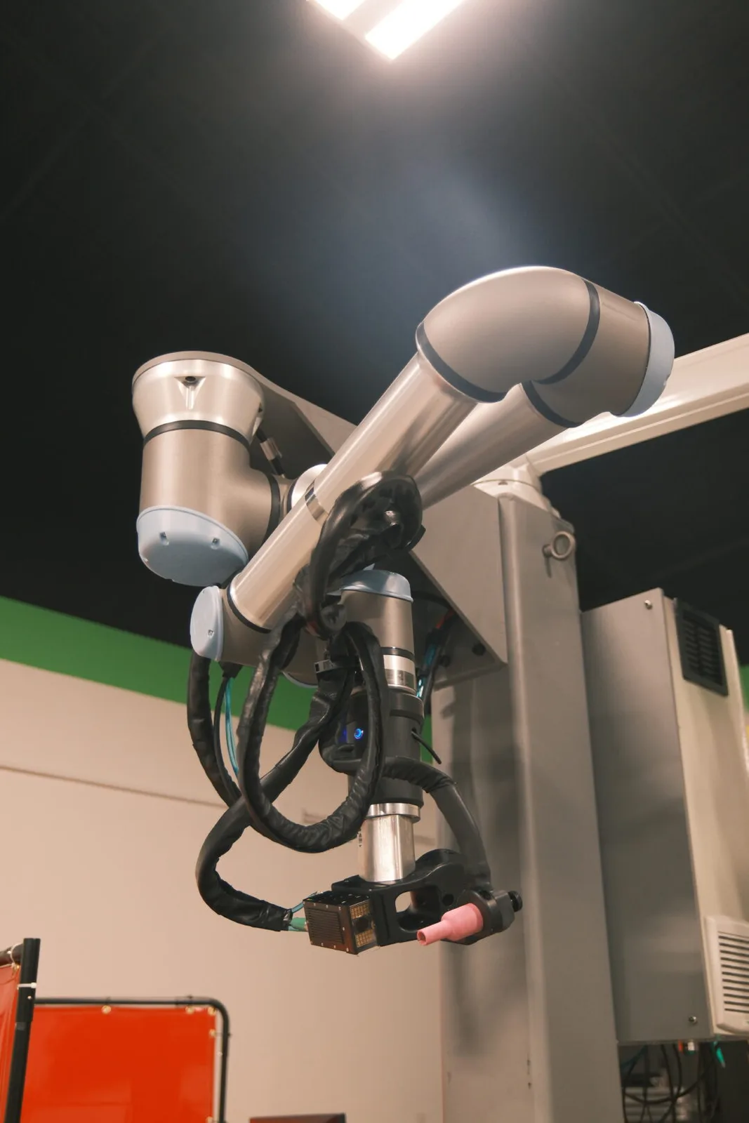 Close-up of the six-axis cobot arm that drives the AutonoWeld M4 welding torch