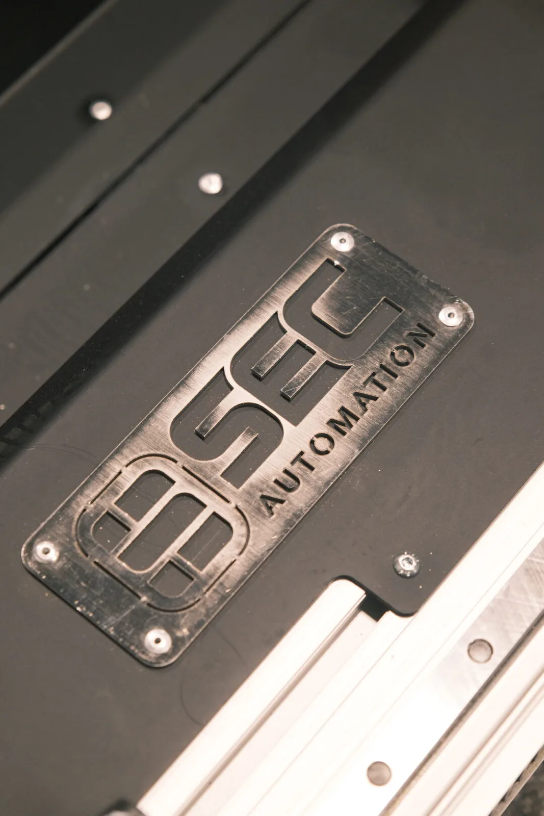 SEC Automation badge mounted on the AutonoWeld M4 welding machine